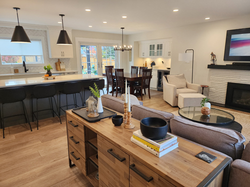 coquitlam-1 A spacious kitchen and living room combined, highlighted by a charming fireplace that adds warmth to the space.